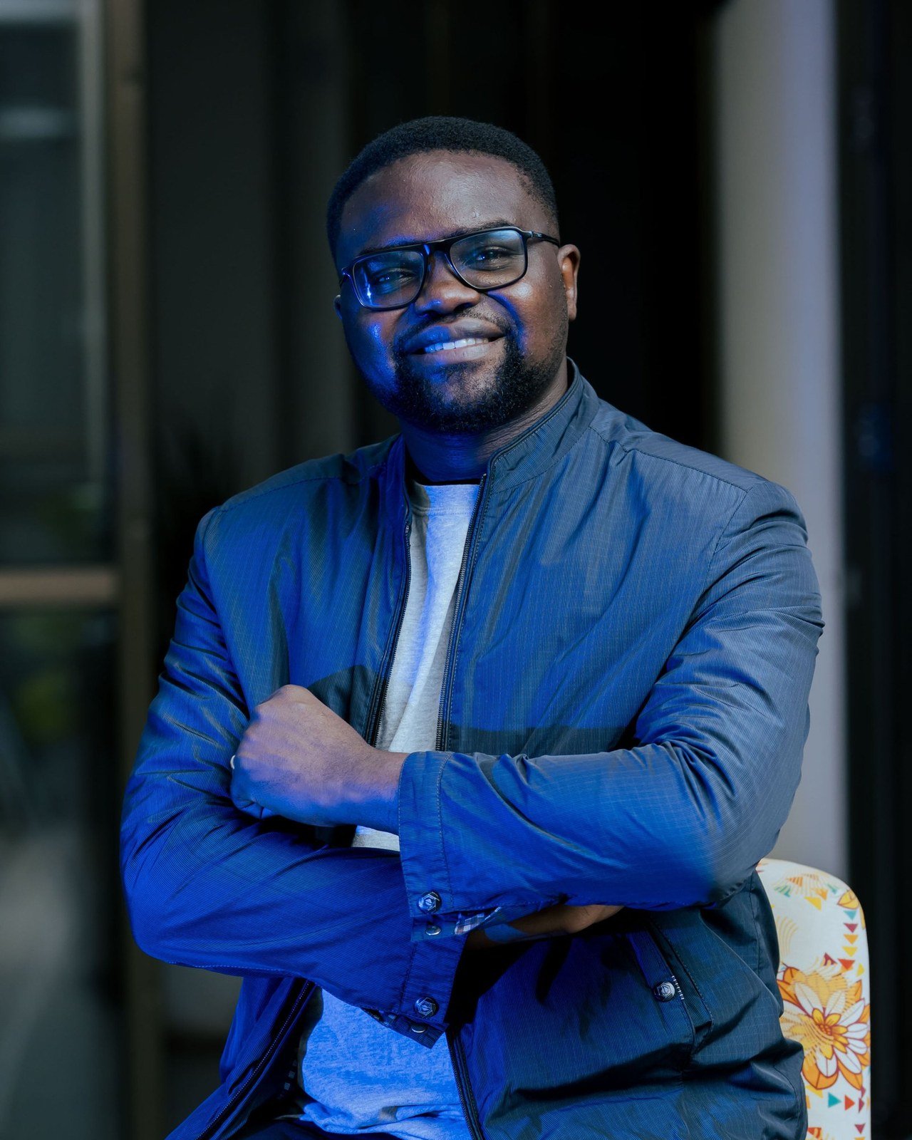 Joshua Pi'Rwot, smiling, in a blue jacket